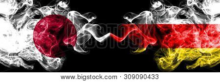 Japan Vs South Ossetia Smoky Mystic Flags Placed Side By Side. Thick Colored Silky Smokes Combinatio