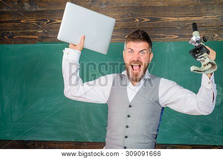 Educational Process. Screaming Tutor With Laptop And Microscope. Docent In Chemistry Or Biology Less