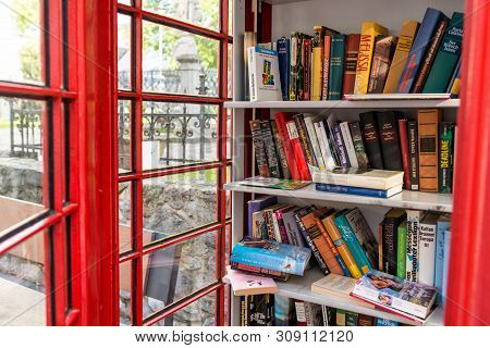 Konigswinter, Germany - 23 May 2019. A Red Telephone Booth For The Free Exchange Of Books.