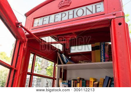 Konigswinter, Germany - 23 May 2019. A Red Telephone Booth For The Free Exchange Of Books.