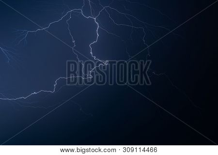 Lightning in the night sky during a severe thunderstorm