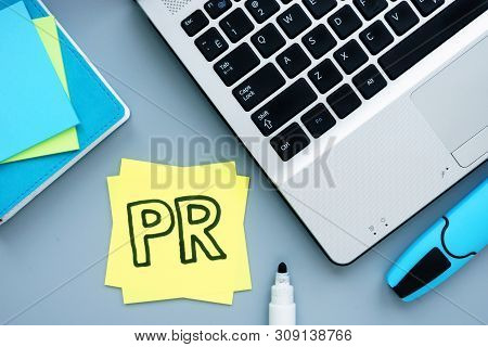 Pr Public Relations Concept. Workplace With Laptop And Notepad.