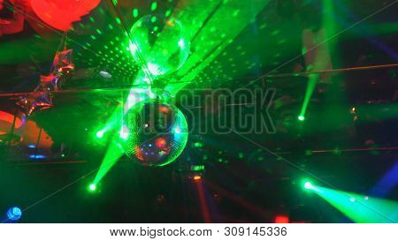 Multi-colored Laser Beams And Fog In Dark Proceeding From Disco Club Laser Show Smoke