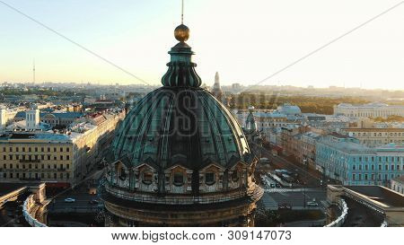 Tremendous Green Dome Lit By Sunset Against Endless City
