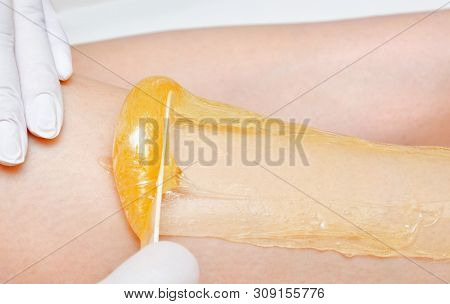 Cosmetologist Beautician Waxing Female Legs In The Spa Center Beauty Salon Cosmetology Concept