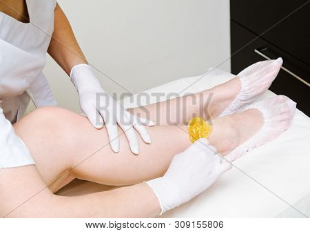 Cosmetologist Beautician Waxing Female Legs In The Spa Center Beauty Salon Cosmetology Concept