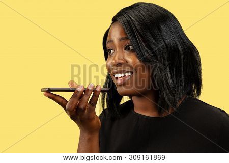Young African-american Woman Isolated On Yellow Studio Background, Facial Expression. Beautiful Fema