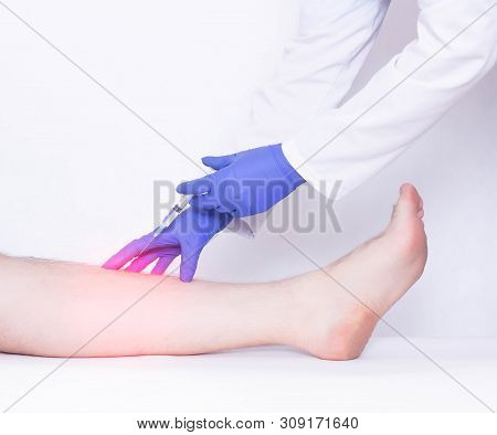 The Doctor Makes An Injection Into The Calf Muscle To The Patient Of An Anti-inflammatory Drug To Re