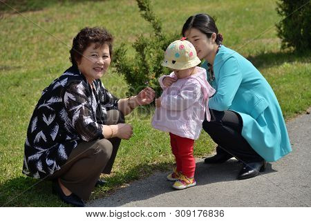 Pyongyang, North Korea - May 1, 2019: Locals In The Taesongsan Funfair. Is An Amusement Park Located