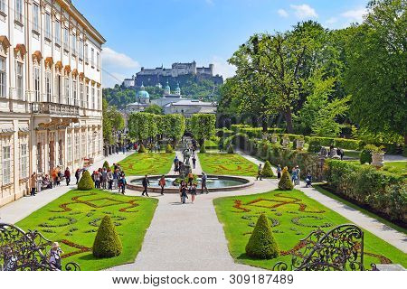 Salzburg, Austria - May 23, 2018 : People Walk Among Flower Beds In The Mirabell Park In Salzburg, O