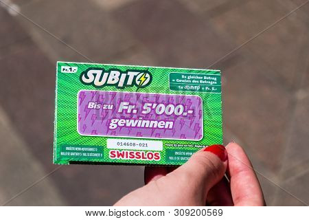 Lugano, Switzerland - June 1, 2019: Subito Swisslos Lottery Scratch Card In Woman Hand.
