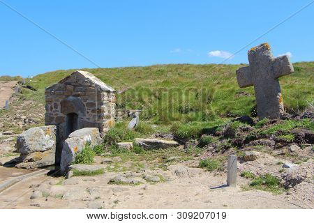 Fountain And Cross Of Saint Samson Chapel On The Coast Of Landunvez