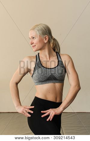 Beautiful Blonde Female Trainer Showing Her Muscels. Healthy, Active Lifestyle, Losing Weight. Women