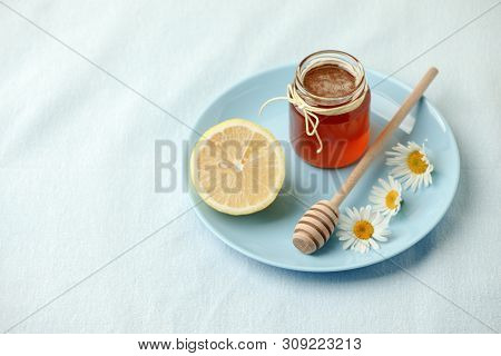 Chamomile Flowers And Chamomile Tea. Chamomile Tea In Glass Teacup With Flowers, Honey And Lemon, To