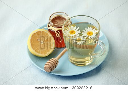 Chamomile Flowers And Chamomile Tea. Chamomile Tea In Glass Teacup With Flowers, Honey And Lemon, To