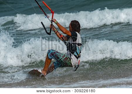 Kitesurfing on the waves of the sea in Mui Ne beach, Phan Thiet, Binh Thuan, Vietnam. Kitesurfing, Kiteboarding action photos Kitesurfer In action