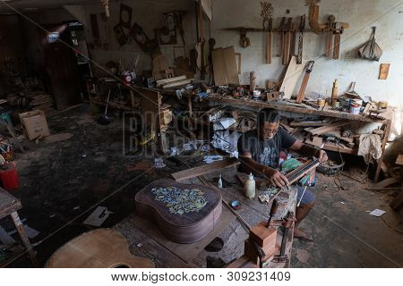 Gianyar,bali/indonesia-may 30 2019: A Guitar Craftsman Is Measuring And Make Sure It Is A Precision