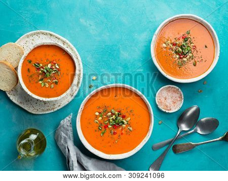 Gaspacho Soup On Blue Tabletop. Three Bowls Of Traditional Spanish Cold Soup Puree Gaspacho Or Gazpa