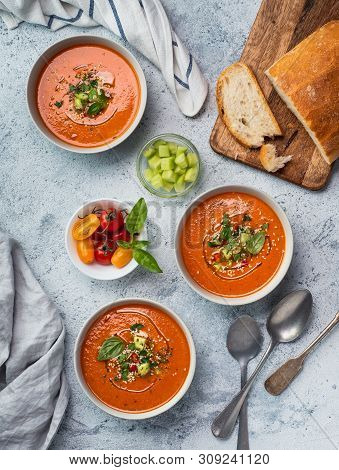 Gaspacho Soup On White Marble Tabletop. Three Bowls Of Traditional Spanish Cold Soup Puree Gaspacho 