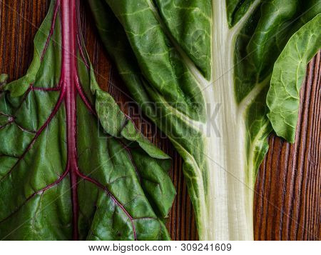 Fresh Raw Leaves Of Chard, Leaf Beets, Mangold, Swiss Chard On A Wooden Table, Close Up