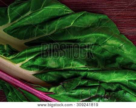 Fresh Raw Leaves Of Chard, Leaf Beets, Mangold, Swiss Chard On A Wooden Table, Copy Space