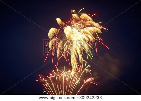 Bright Salute Against The Night Sky, Slightly Blown Away By The Wind, Red-yellow, With Green Inflect
