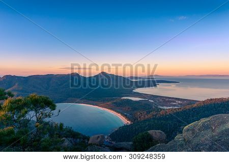 Birds Eye View Of Wineglass Bay Beach At Sunrise. Mountains And Beautiful Beach Landscape In The Mor