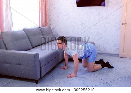 Funny Nerd Man In Glasses And Shorts Is Doing Stretching Exercise For Back Standing On All Fours At 