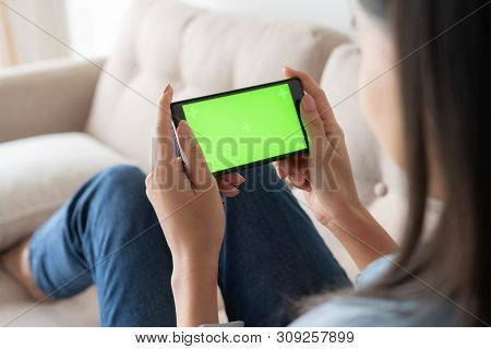 Close Up  Asian Woman Hand Touching Smartphone  Screen Green On Sofa In Living Room At Home