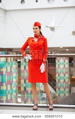 RUSSIA, MOSCOW: 28 JUNE 2019. Beautiful stewardess dressed in official red uniform of Aeroflot Airlines on airport