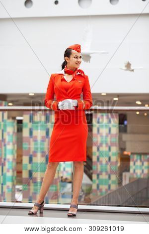 RUSSIA, MOSCOW: 28 JUNE 2019. Beautiful stewardess dressed in official red uniform of Aeroflot Airlines on airport