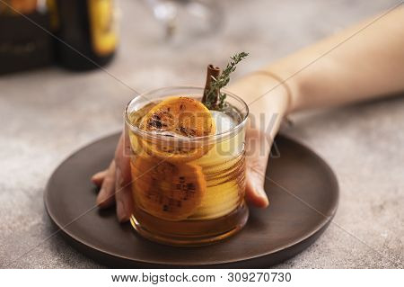 Woman Hand Holding Glass With Whiskey Sour Cocktail. Alcohol Drink Background.