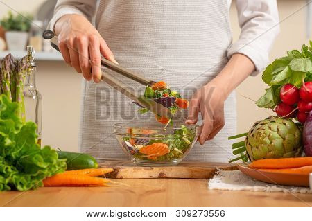 The Chef Prepares A Fresh And Bright Salad Close-up,on A Light Background. The Concept Of Losing Hea