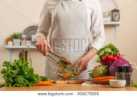 The Chef Prepares A Fresh And Bright Salad, With Vegetables On A Light Background. The Concept Of Lo