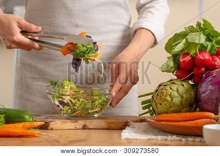 The Chef Prepares A Fresh And Bright Salad Close-up,on A Light Background. The Concept Of Losing Hea