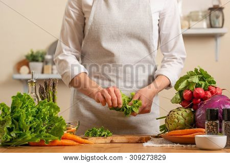 Chef Cuts Fresh Green Salad. The Concept Of Losing Healthy And Wholesome Food, Detox, Vegan Eating,