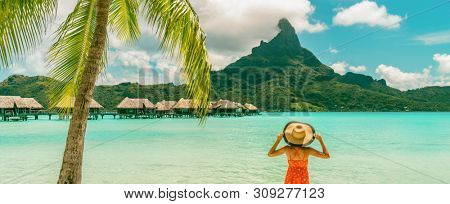 Bora Bora Tahiti luxury beach vacation woman happy enjoying sun on Bora Bora private island, French Polynesia with Mount Otemanu in background and overwater bungalows hotel banner panorama.