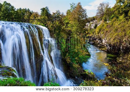 Scenic waterfall cascades on the river Sluncica. Magnificent Southern Europe, Croatia, small town Slunj. Beautiful day. The concept of ecological, active and photo tourism