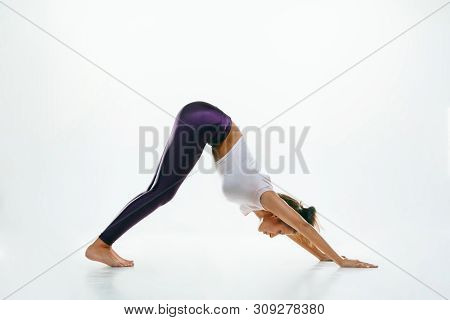 Sporty Young Woman Doing Yoga Practice Isolated On White Studio Background. Fit Flexible Female Mode