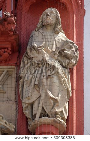 WURZBURG, GERMANY - JULY O4, 2018: Saint Thomas the Apostle statue on the portal of the Marienkapelle in Wurzburg, Bavaria, Germany