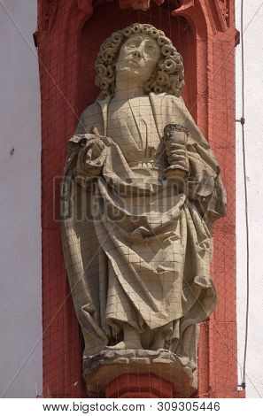 WURZBURG, GERMANY - JULY O4, 2018: Saint John the Apostle statue on the portal of the Marienkapelle in Wurzburg, Bavaria, Germany