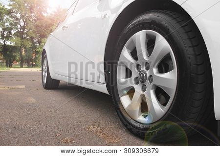Kiev, Ukraine - July 2, 2018: White Opel Insignia, View Of The Car From The Bottom. Car Wheels Close