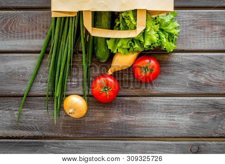 Healthy Food With Fresh Vegetables In Paper Bag On Wooden Background Top View