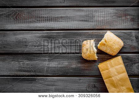 Fresh Baguette And Paper Bag For Bakery On Wooden Background Top View Mock-up