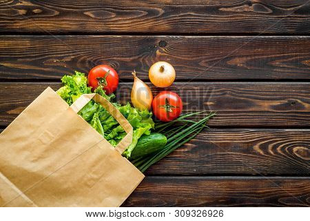 Healthy Food With Fresh Vegetables In Paper Bag On Wooden Background Top View Space For Text