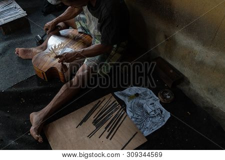 Gianyar,bali/indonesia-may 30 2019: A Guitar Craftsman Are Carving A Classical Guitars Made From Woo