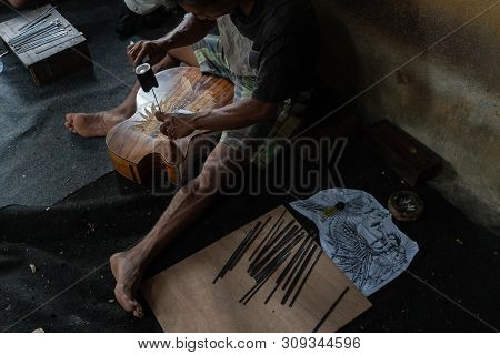 Gianyar,bali/indonesia-may 30 2019: A Guitar Craftsman Are Carving A Classical Guitars Made From Woo