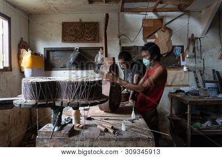 Gianyar,bali/indonesia-may 30 2019: A Guitar Craftsman Is Measuring And Make Sure It Is Precision In