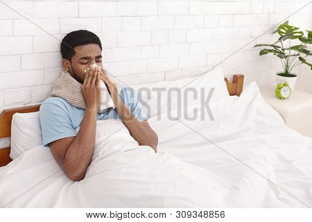 Sick Black Man Cleaning Snotty Nose, Lying With Fever In Bed, Free Space