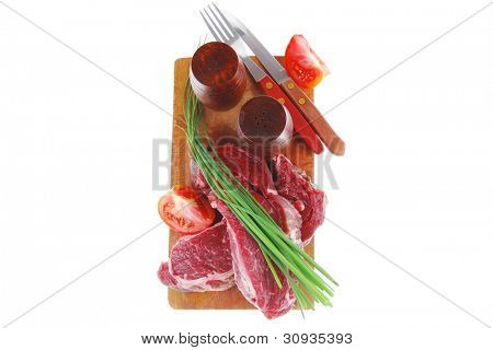 meat portion: bloody beef fillet on plate with cutlery served before cooking